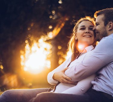 Happy couple laughing together — how to keep the spark alive in a relationship