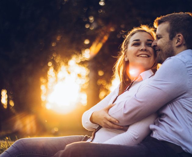 Happy couple laughing together — how to keep the spark alive in a relationship