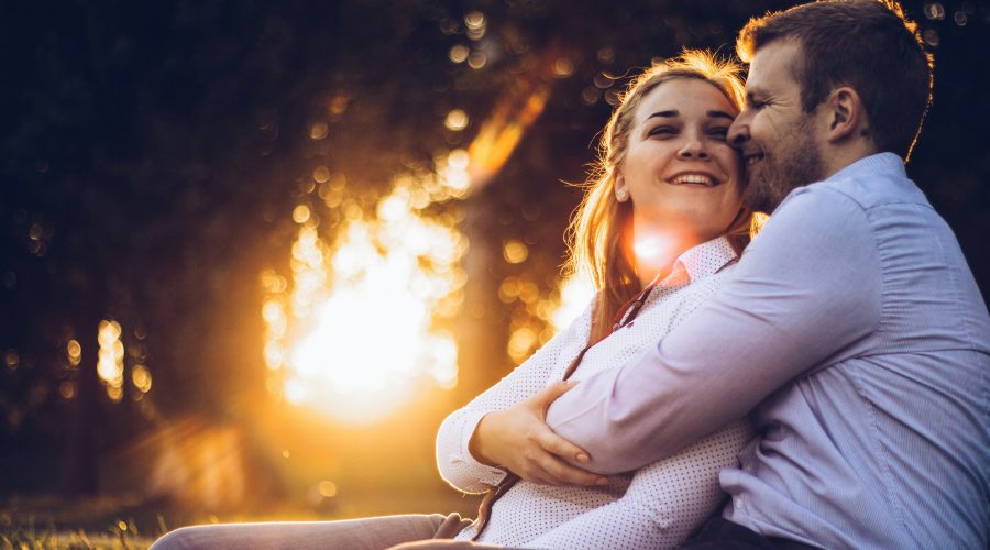 Happy couple laughing together — how to keep the spark alive in a relationship