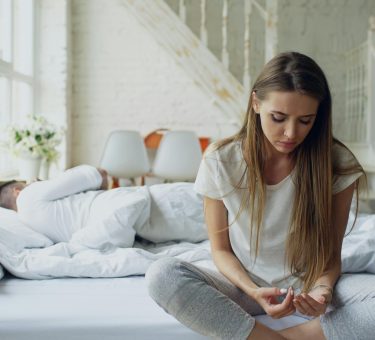 Person sitting alone feeling disconnected — signs of emotional unavailability in a partner