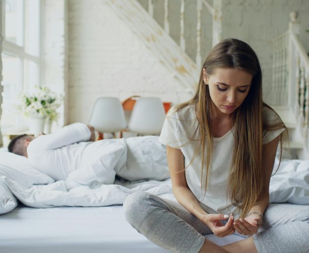 Person sitting alone feeling disconnected — signs of emotional unavailability in a partner