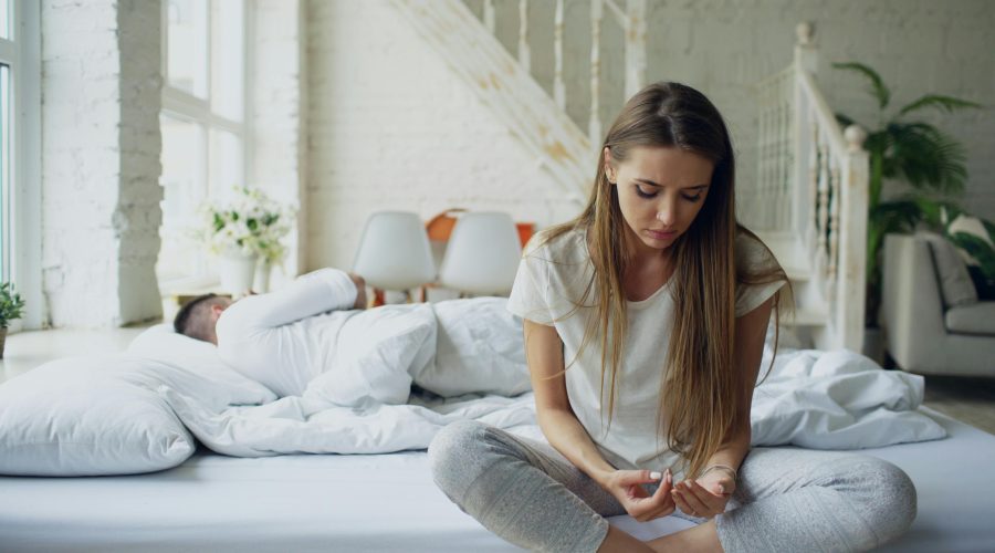 Person sitting alone feeling disconnected — signs of emotional unavailability in a partner