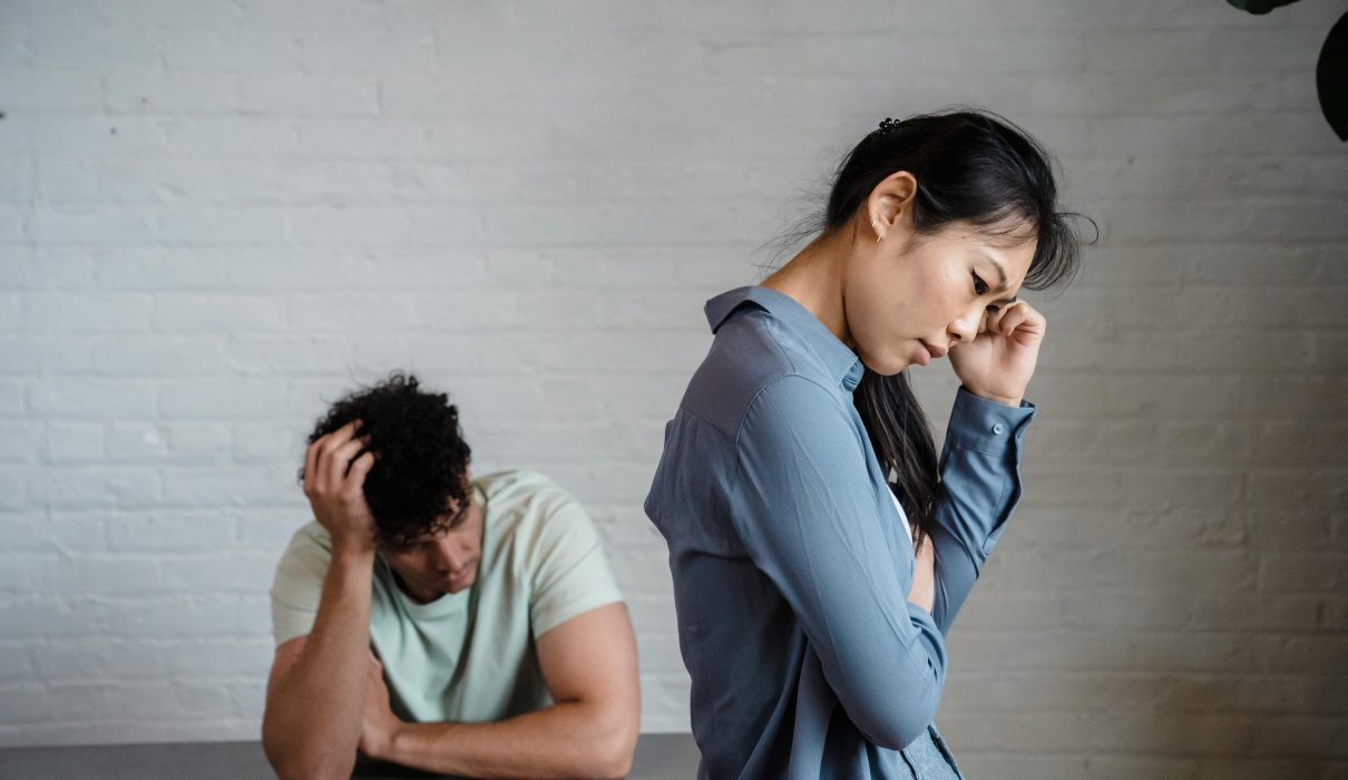 Person looking at phone anxiously — how to deal with jealousy in a relationship