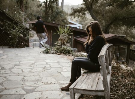 Person checking phone anxiously — how to stop being clingy in a relationship